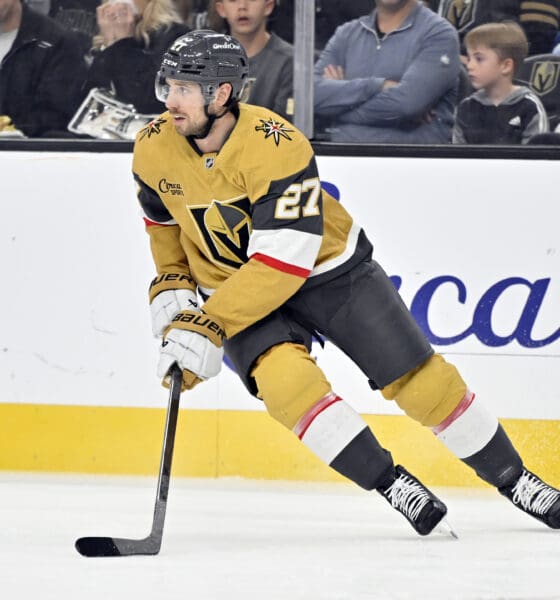 Vegas Golden Knights defenseman Shea Theodore (27) handles the puck against the Calgary Flames during the first period of an NHL hockey game Sunday, Dec. 29, 2024, in Las Vegas. (AP Photo/David Becker)
