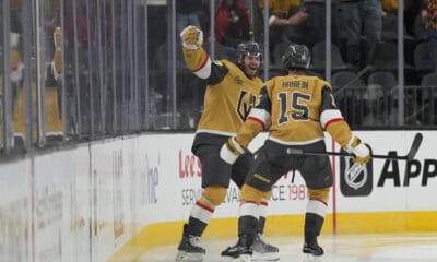Vegas Golden Knights left wing Brandon Saad, left, celebrates after scoring against the Vancouver Canucks during the third period of an NHL hockey game Saturday, Feb. 22, 2025, in Las Vegas. (AP Photo/John Locher)
