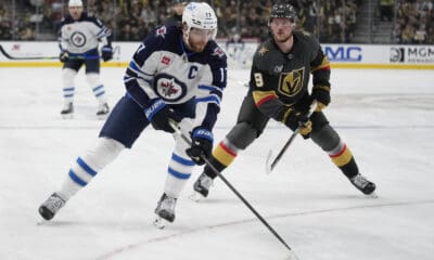 Winnipeg Jets center Adam Lowry (17) skates up the ice against Vegas Golden Knights center Jack Eichel (9) during the first period of an NHL hockey game Thursday, April 3, 2025, in Las Vegas. (AP Photo/John Locher)