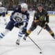 Winnipeg Jets center Adam Lowry (17) skates up the ice against Vegas Golden Knights center Jack Eichel (9) during the first period of an NHL hockey game Thursday, April 3, 2025, in Las Vegas. (AP Photo/John Locher)