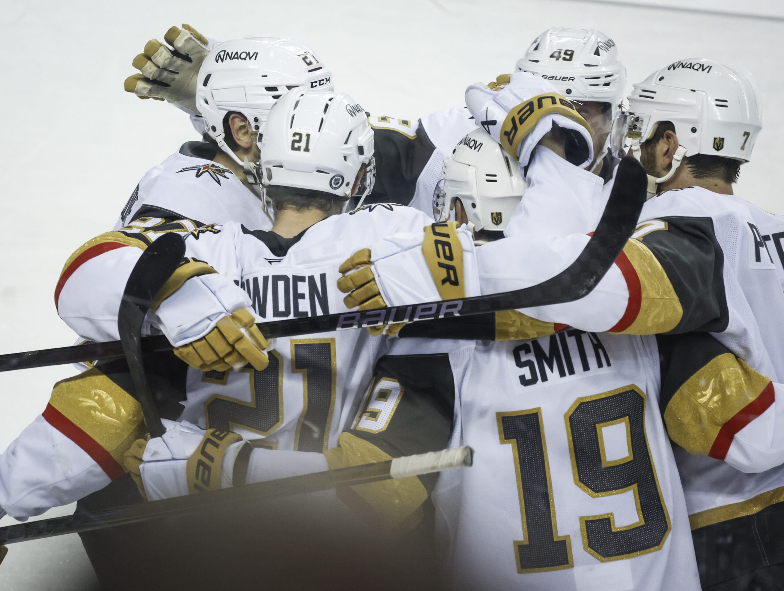 Vegas Golden Knights' Reilly Smith (19) celebrates his game-winning goal with teammates during overtime in an NHL hockey game against the Calgary Flames in Calgary, Alberta, Saturday, April 5, 2025. (Jeff McIntosh/The Canadian Press via AP)