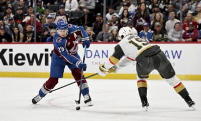 Colorado Avalanche center Nathan MacKinnon (29) skates against Vegas Golden Knights defenseman Noah Hanifin (15) in the first period of an NHL hockey game Tuesday, April 8, 2025, in Denver. (AP Photo/Geneva Heffernan)