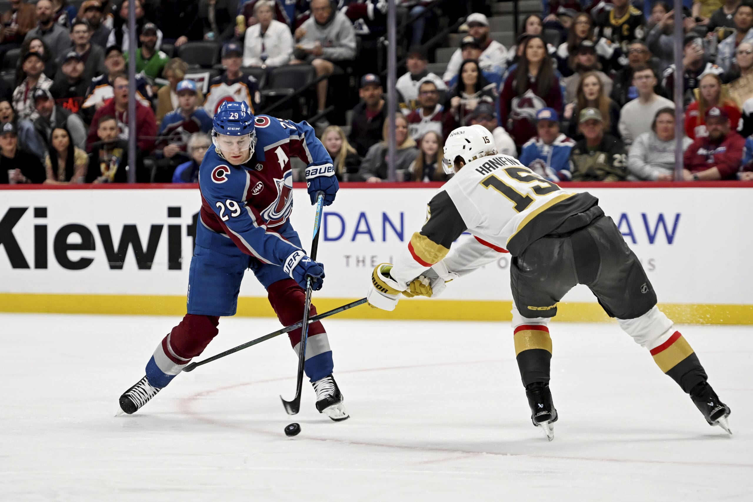 Colorado Avalanche center Nathan MacKinnon (29) skates against Vegas Golden Knights defenseman Noah Hanifin (15) in the first period of an NHL hockey game Tuesday, April 8, 2025, in Denver. (AP Photo/Geneva Heffernan)
