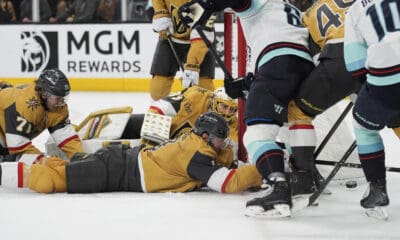 Vegas Golden Knights defenseman Brayden McNabb (3) lies on the ice while battling for th puck against the Seattle Kraken during the third period of an NHL hockey game Thursday, April 10, 2025, in Las Vegas. (AP Photo/John Locher)