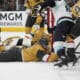 Vegas Golden Knights defenseman Brayden McNabb (3) lies on the ice while battling for th puck against the Seattle Kraken during the third period of an NHL hockey game Thursday, April 10, 2025, in Las Vegas. (AP Photo/John Locher)
