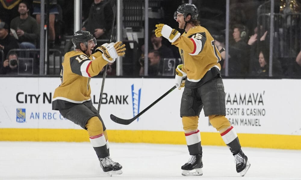 Vegas Golden Knights right wing Reilly Smith (19) celebrates after Vegas Golden Knights defenseman Noah Hanifin, right, scored against the Nashville Predators during the third period of an NHL hockey game Saturday, April 12, 2025, in Las Vegas. (AP Photo/John Locher)