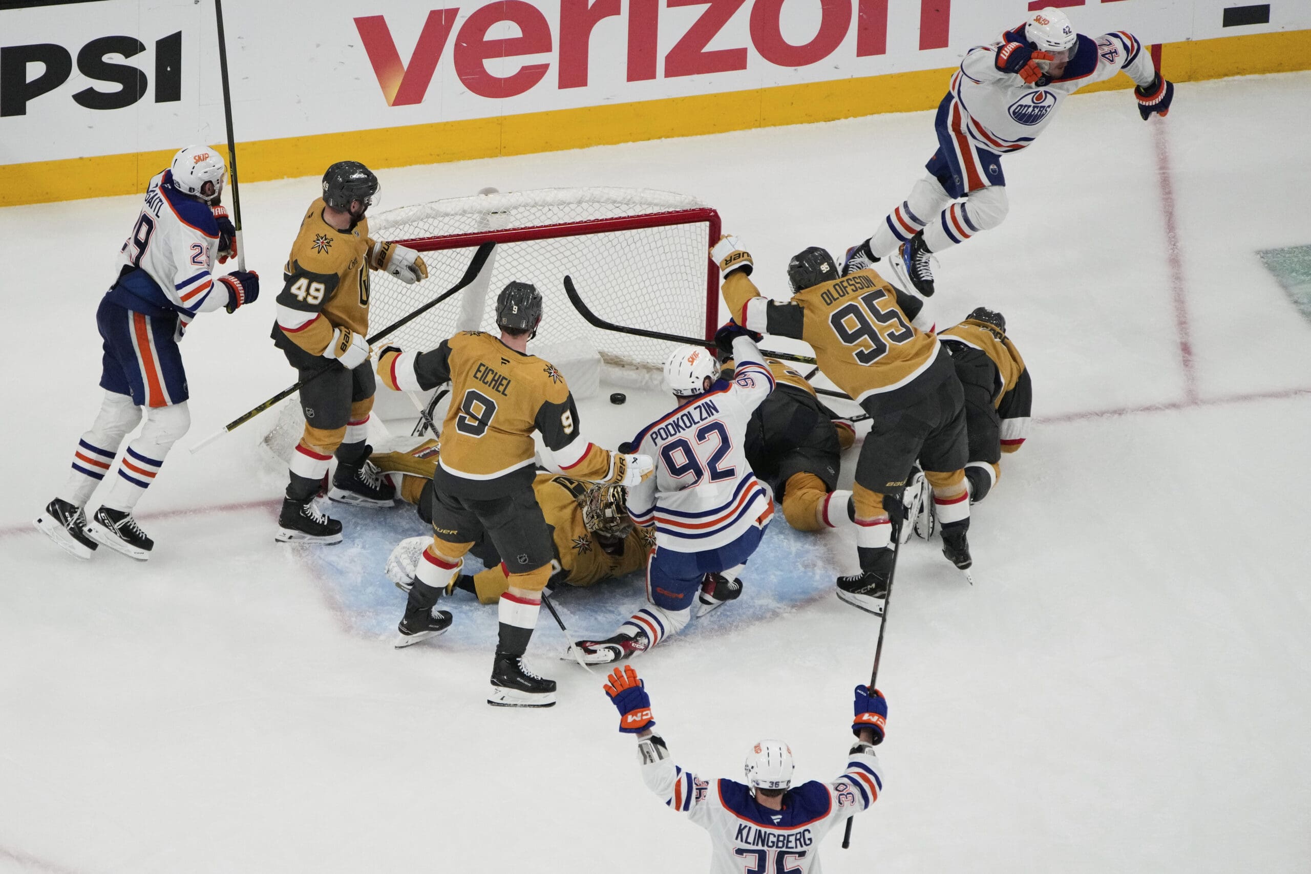 Edmonton Oilers right wing Kasperi Kapanen, upper right, celebrates after scoring against the Vegas Golden Knights during overtime of Game 5 of a second-round NHL hockey playoff series Wednesday, May 14, 2025, in Las Vegas. (AP Photo/John Locher)