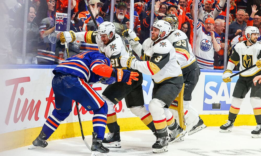 EDMONTON, AB - MAY 12: Las Vegas Golden Knights Center Brett Howden (21) and Las Vegas Golden Knights Goalie Aden Hill (33) attack Edmonton Oilers Right Wing Evander Kane (91) in the first period of the Stanley Cup Playoffs Second Round Edmonton Oilers game versus the Las Vegas Golden Knights on May 12, 2025 at Rogers Place in Edmonton, AB. (Photo by Curtis Comeau/Icon Sportswear)
