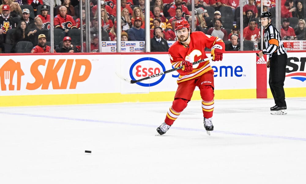 CALGARY, AB - OCTOBER 18: Calgary Flames Defenceman Rasmus Andersson (4) passes the puck during the second period of an NHL game between the Calgary Flames and the Vegas Golden Knights on October 18, 2022, at the Scotiabank Saddledome in Calgary, AB. (Photo by Brett Holmes/Icon Sportswire)