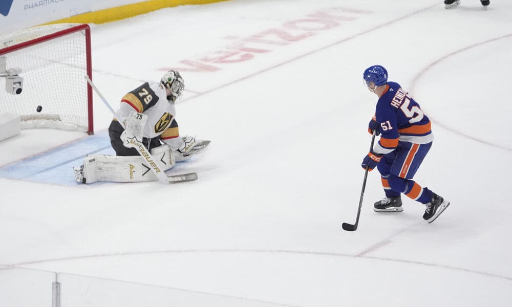 ELMONT, NY - DECEMBER 09: New York Islanders Left Wing Emil Heineman (51) scores the winning goal against Vegas Golden Knights Goalie Carter Hart (79) during the shootout of the National Hockey League game between the Vegas Golden Knights and the New York Islanders on December 9, 2025, at UBS Arena in Elmont, NY. (Photo by Gregory Fisher/Icon Sportswire)