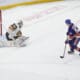ELMONT, NY - DECEMBER 09: New York Islanders Left Wing Emil Heineman (51) scores the winning goal against Vegas Golden Knights Goalie Carter Hart (79) during the shootout of the National Hockey League game between the Vegas Golden Knights and the New York Islanders on December 9, 2025, at UBS Arena in Elmont, NY. (Photo by Gregory Fisher/Icon Sportswire)